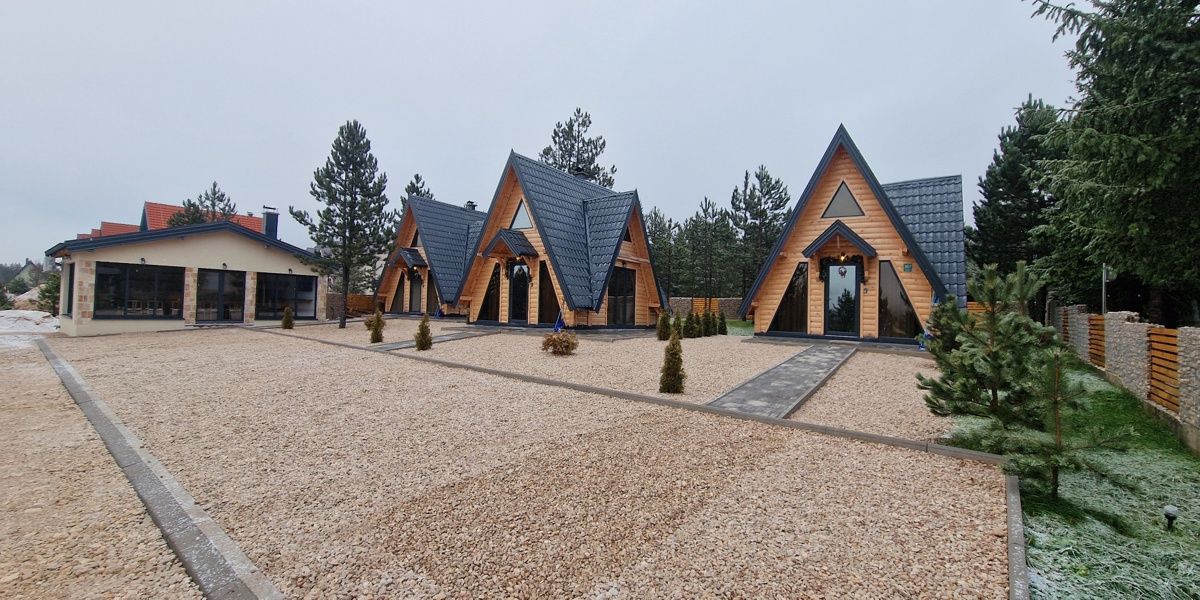 Mountain accommodation with snow-covered landscape and pine forests in Blidinje